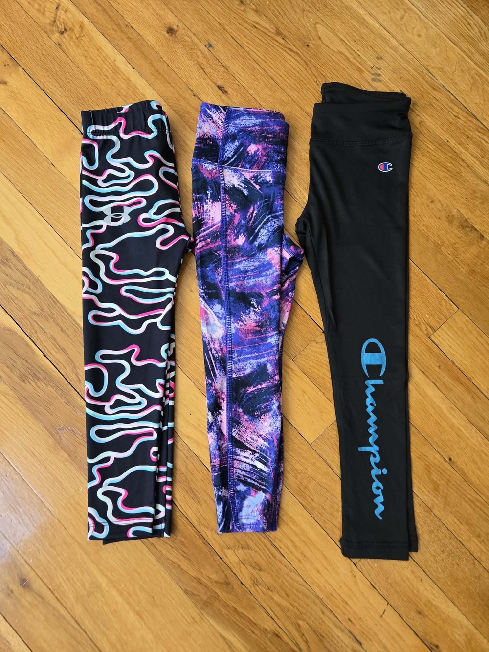 Champion Black Leggings with Turquoise Logo and Multicolor Patterned Pair